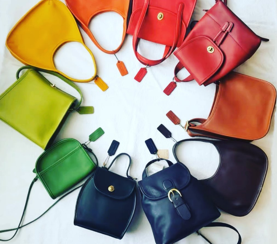 Find your dream bag today! Displayed here is a collection of vintage Coach bags of various colors. 